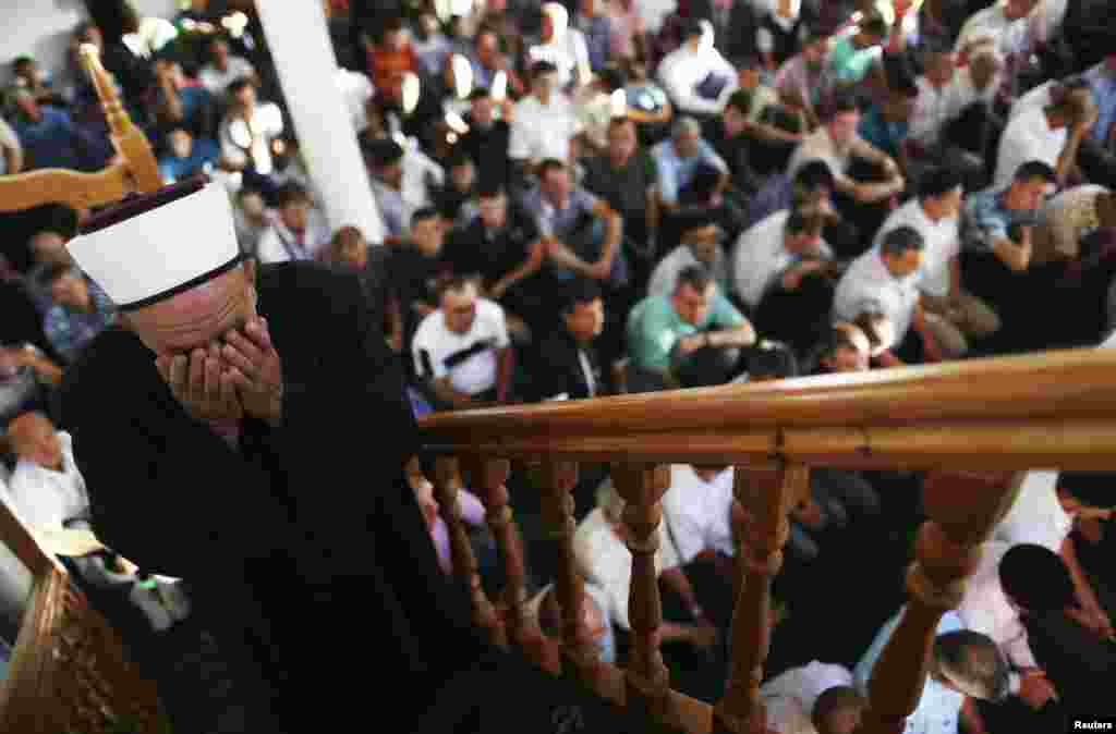 A Bosnian priest leads morning prayers on the first day of Eid in the village of Mjestova Ravna.