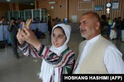 Fatema Qaderyan with her late father at Herat International Airport in July 2017.