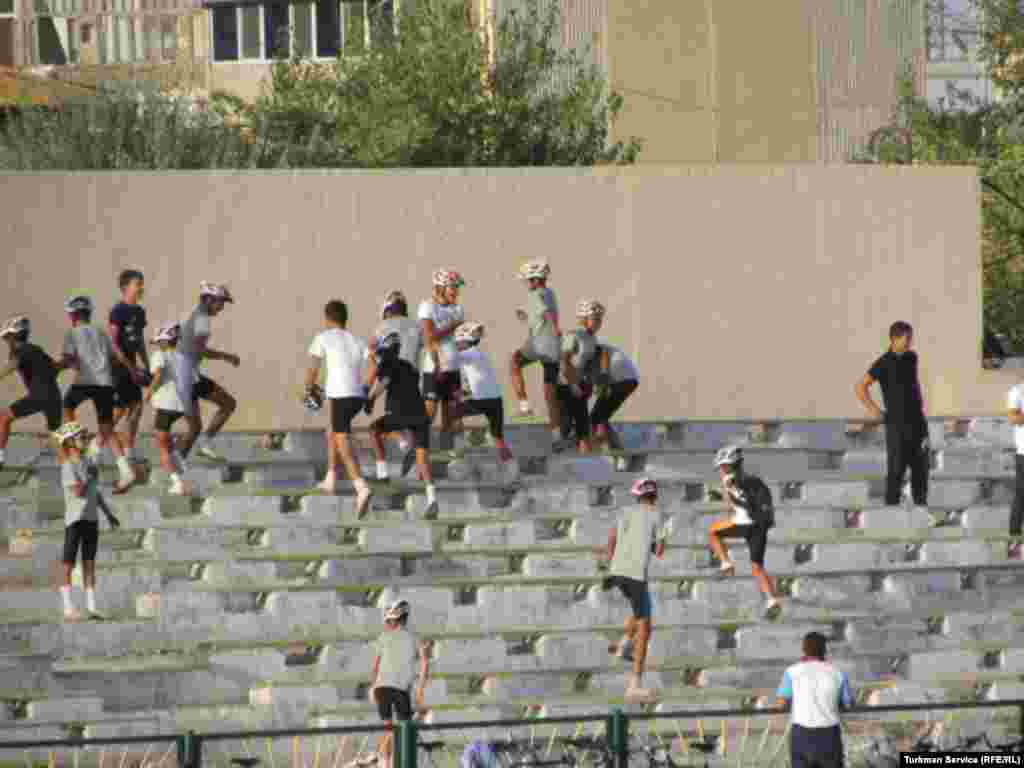 During rehearsals for Turkmenistan's Independence Day celebrations, children in biking gear climb the stands of the Labor Stadium in the city of Turkmenabat, leaving their bikes behind at the bottom.