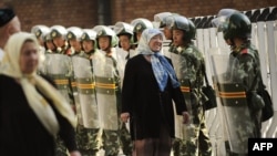 Уйгурская женщина разговаривает с китайскими солдатами, охраняющими Большой базар в Урумчи, на западе Китая. Синьцзян, 9 июля 2009 года