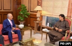 Pakistani Prime Minister Imran Khan (right) meets with U.S. envoy Zalmay Khalilzad in Islamabad on August 1.