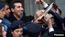 Armenia - U.S.-Armenian rock singer Serj Tankian is mobbed by fans in Yerevan, 25Apr2015.