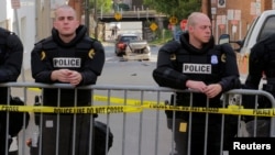 Полицейские стоят в оцеплении места в Шарлотсвилле, где автомобиль врезался в толпу