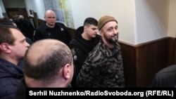 Andriy Antonenko is led by police officers to a court hearing in Kyiv earlier this year. 