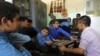 Visually impaired Afghan students play musical instruments during a music lesson at the Kabul Blind School.