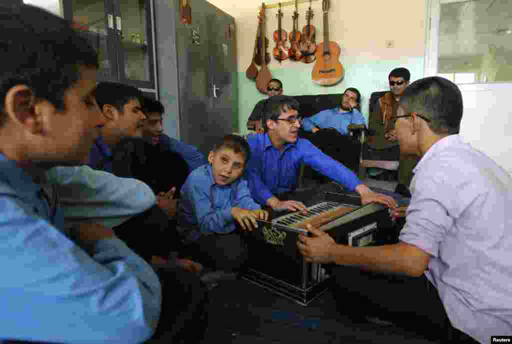 Students play musical instruments during a music lesson at the school.