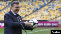 Ukrainian President Viktor Yanukovych plays around in Kyiv's Olympic Stadium, one of the scheduled venues for Euro 2012.