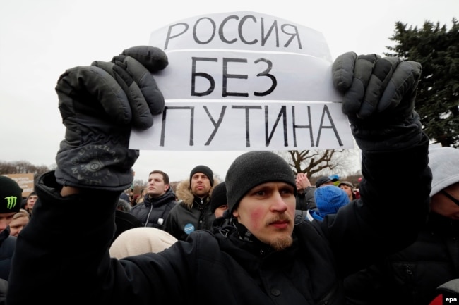 A youthful protester holds a poster reading 'Russia without Putin' as he takes part in an anticorruption rally in St. Petersburg on March 26.