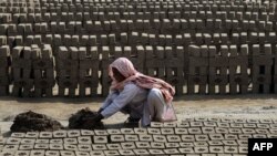 A female laborer makes bricks at a factory on the outskirts of Lahore. (file photo)