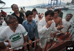 Asylum seekers arrive in Indonesia at the port in Merak in 2012.
