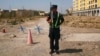 A Chinese police officer stands in position on a road near what is officially called a vocational education center in Xinjiang, China. Critics say such facilities are being used as mass internment camps. (file photo)