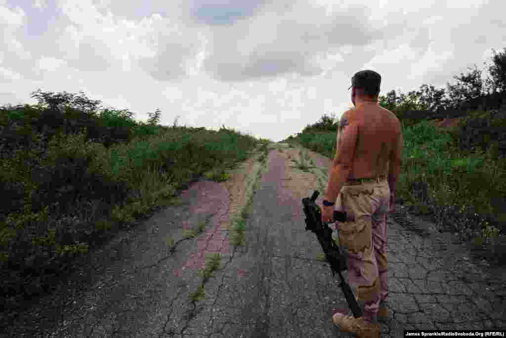 A commander surveys a road that leads to separatist-held territory.