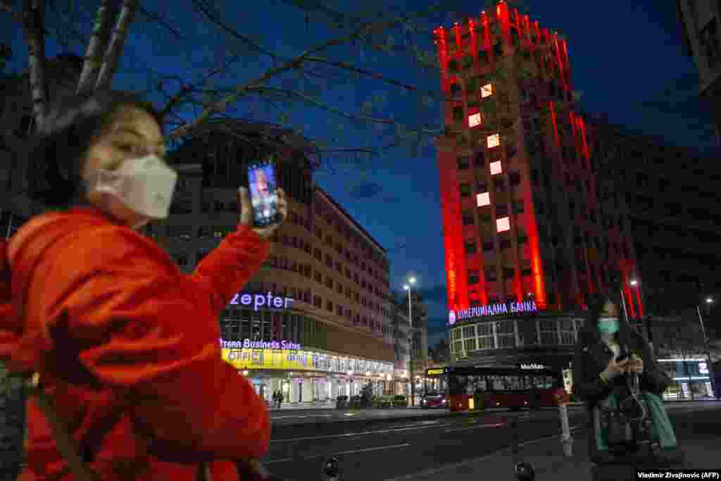 The Palace Albania building in central Belgrade lit up in the colors of the Chinese flag on March 21. Zoric says while some billboards have been rented by government-friendly media, other pro-Chinese displays have been paid for by city authorities.