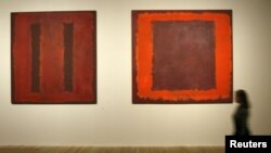 A gallery worker walks past Seagram murals by Russian-born U.S. painter Mark Rothko at the Tate Modern in London in 2008.