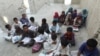 Pupils in the Kuchu village in southeastern province of Sistan and Baluchistan study in a ruined building.