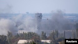 The traffic-control tower of Donetsk's Sergei Prokofiyev International Airport is seen through smoke during fighting between pro-Russian rebels and Ukrainian government forces in Donetsk on October 3.