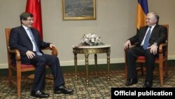 Turkish Foreign Minister Ahmet Davutoglu (left) and Armenian Foreign Minister Edward Nalbandian meet in Yerevan on December 12. 