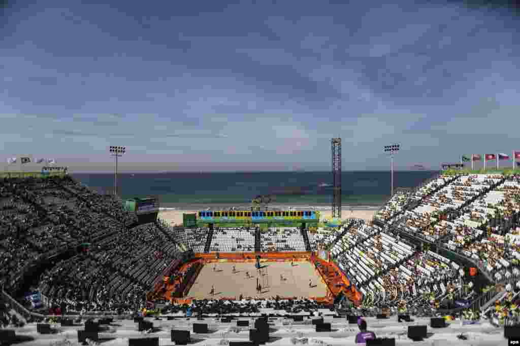 Larissa Franca Maestrini and Talita Rocha of Brazil (left) play Ekaterina Birlova and Evgenia Okolova of Russia at the Beach Volleyball Arena on Copacabana Beach.