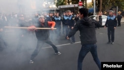 Armenia - Shant Harutiunian (L) clashes with another man during an anti-government demonstration in Yerevan, 5 November, 2013.