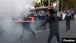 Armenia -- Political activist Shant Harutiunian (L) clashes with another man during an anti-government protest in downtown Yerevan during , 5Nov2013.