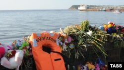 Stuffed toys, flowers, and other tributes left by people on the shore of the Volga River, near where the "Bulgaria" sank in July.