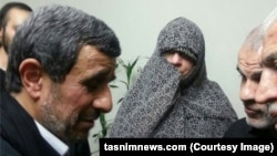 Former Iranian President Mahmud Ahmadinejad (right) visits the family of one of his ex-bodyguards, who was killed in Syria. 