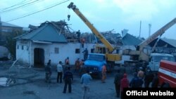 Authorities try to remove and sift through damage on November 3 after a roof collapsed at the Kara-Suu market in the Osh region of southern Kyrgyzstan.