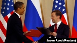 U.S. President Barack Obama (left) and Russian President Dmitry Medvedev shake hands as they exchange signed documents on nuclear arms reduction in Moscow in July 2009.