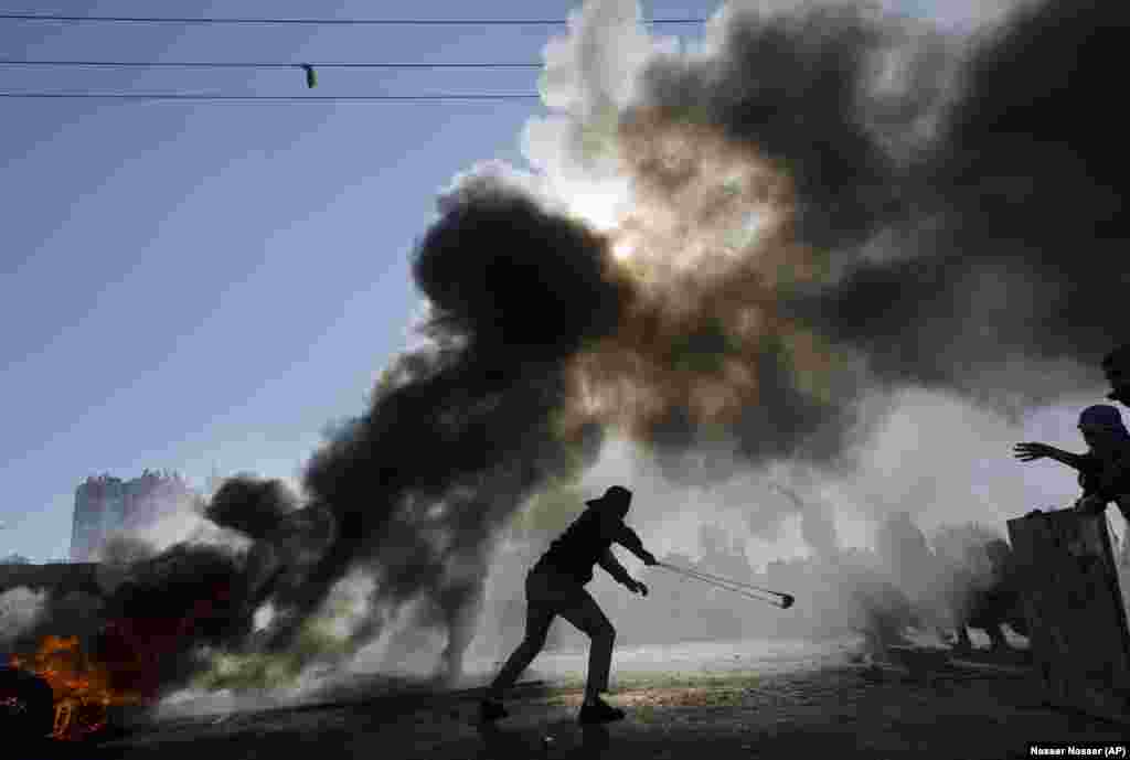 Palestinians burn tires and clash with Israeli troops&nbsp;in the West Bank city of Ramallah, during protests against U.S. President Donald Trump&#39;s decision to recognize Jerusalem as the capital of Israel. December 8, 2017. (AP/Nasser Nasser)