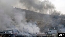 Smoke rises the destroyed police headquarters in Cizre, southeastern Turkey after a suicide truck bombing killed 11 police officers and injured 78 people, in an attack on August 26.