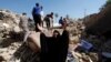 A woman reacts at the site of a suicide bomb attack on a Shi'ite mosque in Mussayab on September 30.