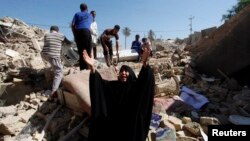 A woman reacts at the site of a suicide bomb attack on Shi'ite mosque in Mussayab, south of Baghdad, on September 30.