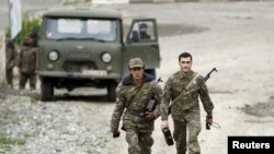 Nagorno-Kararbakh -- Servicemen of the self-defense army of Nagorno-Karabakh walk at a military base in the village of Mataghis, April 6, 2016