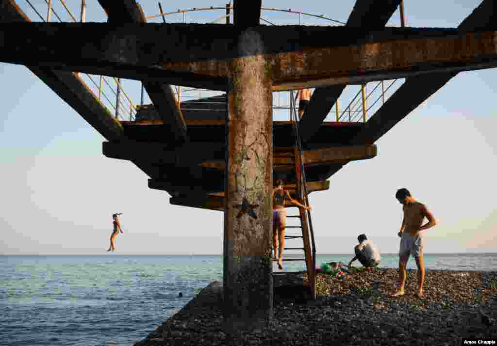 Sukhumi locals on a ruined pier. Abkhazia accounts for much of Georgia&rsquo;s coastline and was a popular resort destination in the Soviet era.