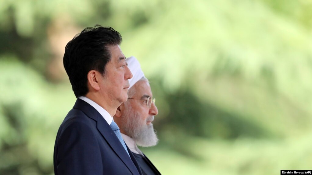 IRAN -- Japanese Prime Minister Shinzo Abe, left, is welcomed by Iranian President Hassan Rohani, during an official arrival ceremony at the Saadabad Palace in Tehran, IJune 12, 2019