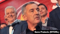 Montenegro's outgoing Prime Minister Milo Djukanovic (center), with close ally Dusko Markovic (left), who was named to succeed him