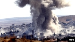 Smoke rises after an airstrike by a suspected alliance war plane on Islamic State targets in the west of Kobani on October 8.