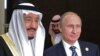 Russian President Vladimir Putin (C) poses with Saudi King Salman bin Abdulaziz Al Saud during a meeting on the sidelines of the G20 summit in Antalya, November 16, 2015