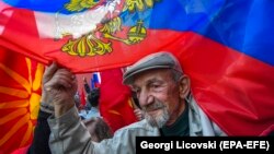 Demonstrators wave Russian and old Macedonian flags as a protest against their government's decision to expel a Russian diplomat in front of the Russian Embassy in Skopje in April.