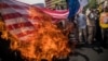 Supporters of the Islamic republic burn a U.S. flag during a protest against President Donald Trump's decision to walk out of a 2015 nuclear deal, in Tehran in May 2018.