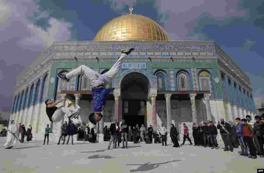 Palestinian youths practice parkour outside the Dome of the Rock mosque at the Al-Aqsa mosque compound following Friday Prayers in the Old City of Jerusalem. (AFP/Ahmad Gharabli)