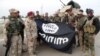 Iraqi security forces stand with an Islamic State flag which they pulled down in the city of Ramadi on February 1. The extremist group has suffered significant losses in Iraq and Syria in recent months. 
