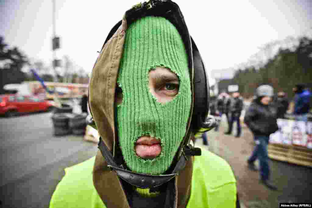 A masked antigovernment demonstrator