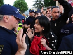 A protester argues with police outside the city's old parliament building on the evening of June 3.