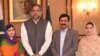 Pakistani Nobel Peace Prize winner Malala Yousafzai (L) and her parents pose for a photograph with Pakistani Prime Minister Shahid Khaqan Abbasi in Islamabad on March 29, 2018