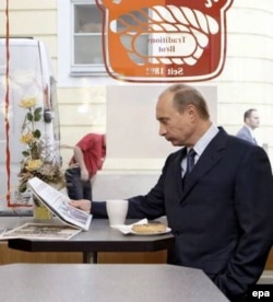 Putin reads a German newspaper in a coffeeshop in Dresden in October 2006.