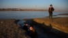 Afghan children play alongside the Amu-Darya River on the border of Afghanistan and Uzbekistan.
