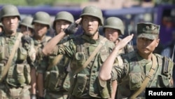 Kyrgyz Army soldiers march in formation in the city of Osh on June 29.