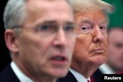 U.S. President Donald Trump reacts as NATO Secretary-General Jens Stoltenberg speaks during a NATO leaders summit in Watford, Britain, on December 4, 2019.