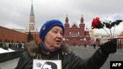 A Communist Party supporter waits to pay her respects recently at the grave of Soviet leader Josef Stalin, at the Kremlin wall on Red Square in Moscow.